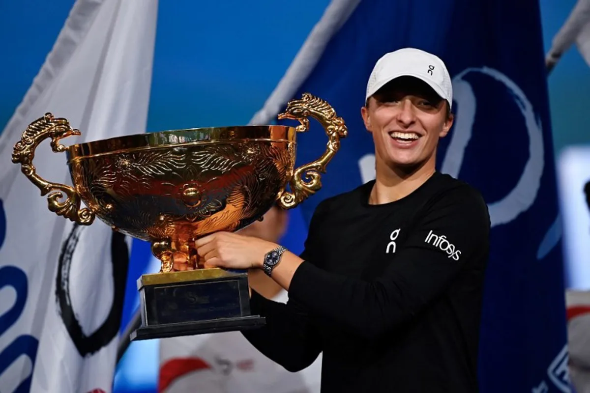 Poland's Iga Swiatek holds the winning trophy after defeating Russia's Liudmila Samsonova in the women's singles final match of the WTA China Open tennis tournament in Beijing on October 8, 2023.  Pedro PARDO / AFP