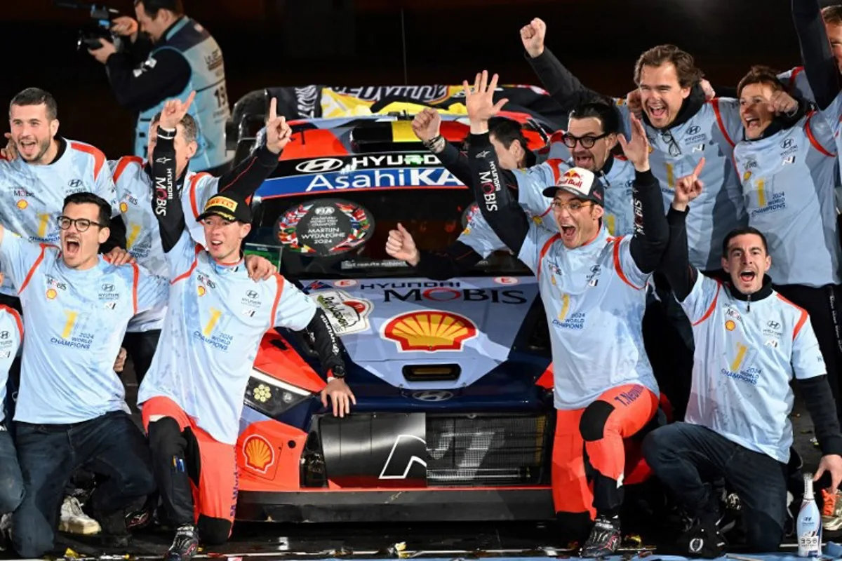 Thierry Neuville and his co-driver Martijn Wydaeghe of Belgium celebrate their World Champion with their team staffs on the podium at the Toyota stadium during the Rally Japan, the 13th and final round of 2024 FIA World Rally Championships, in Toyota city on November 24, 2024.   Toshifumi KITAMURA / AFP