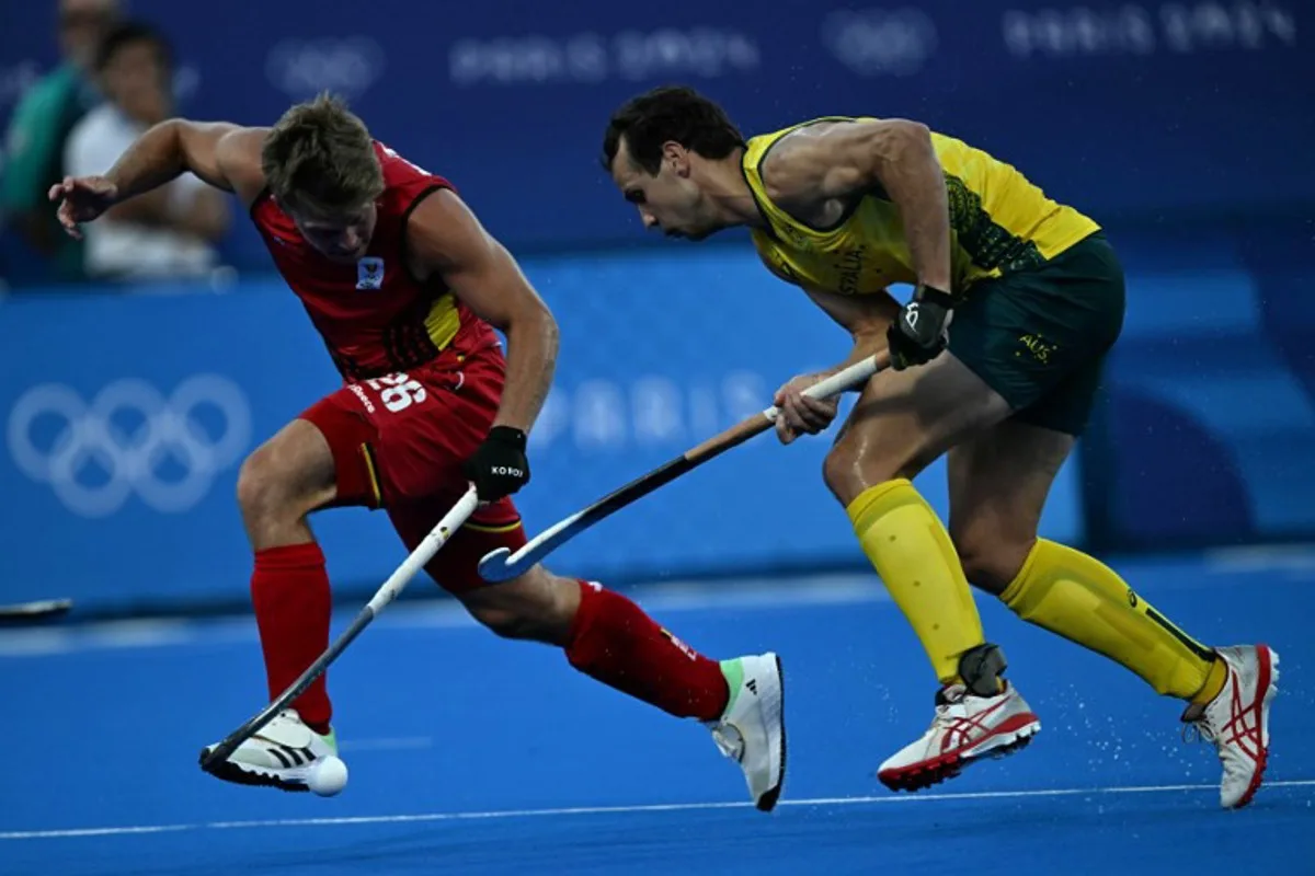 Belgium's midfielder #26 Victor Wegnez fights for the ball with Australia's forward #02 Thomas Craig in the men's pool B field hockey match between Australia and Belgium during the Paris 2024 Olympic Games at the Yves-du-Manoir Stadium in Colombes on July 30, 2024.  Mauro PIMENTEL / AFP