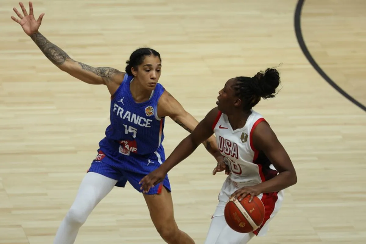 France's forward #15 Gabby Williams and USA's guard #08 Chelsea Gray vie for the ball during the 2026 FIBA Women's Basketball World Cup final game between the United States and France in Berlin on September 13, 2026. Odd ANDERSEN / AFP