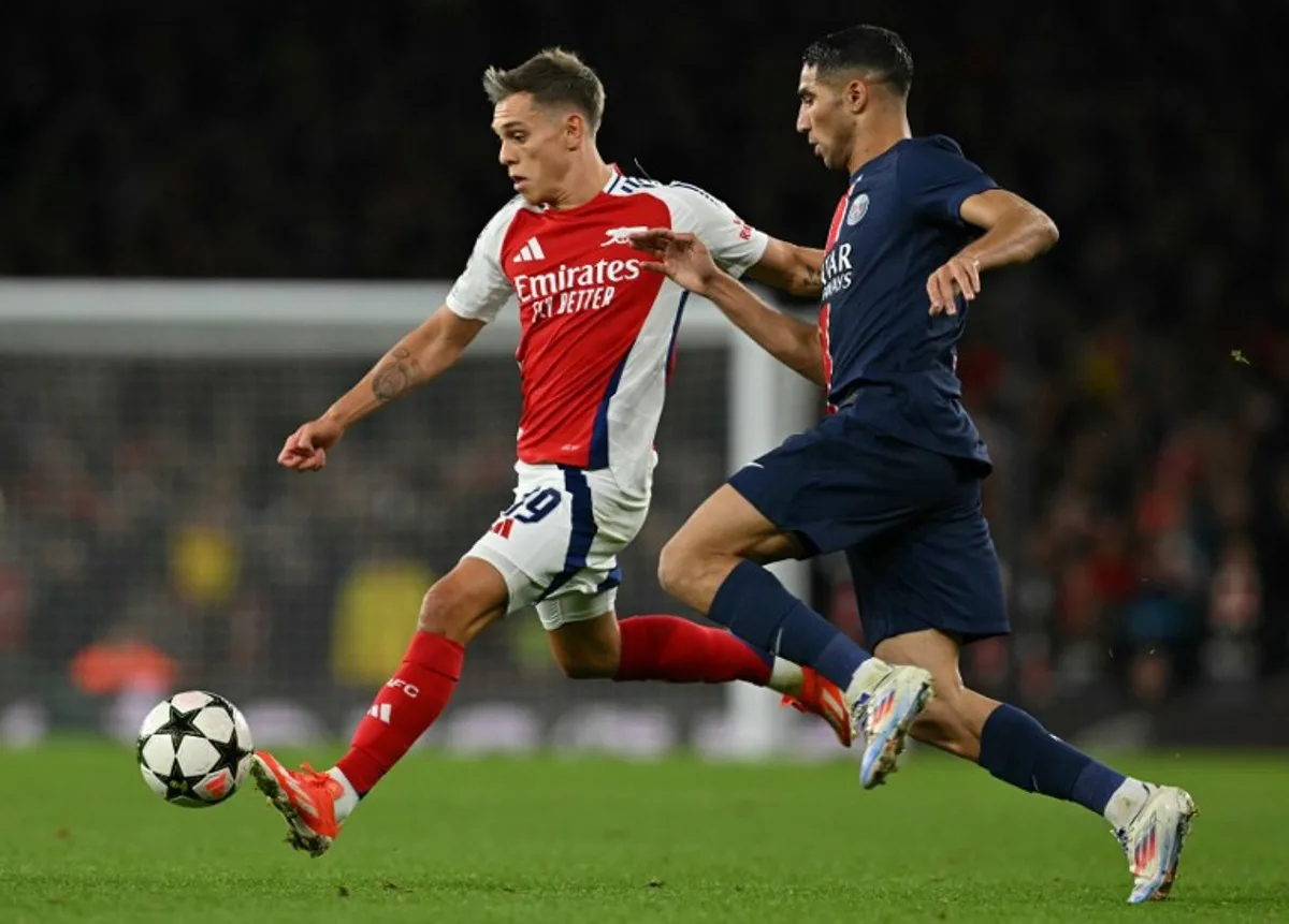 Paris Saint-Germain's Moroccan midfielder #02 Achraf Hakimi (R) vies with Arsenal's Belgian midfielder #19 Leandro Trossard during the UEFA Champions League football match between Arsenal and Paris Saint-Germain (PSG) at the Emirates Stadium in north London on October 1, 2024.  Glyn KIRK / AFP