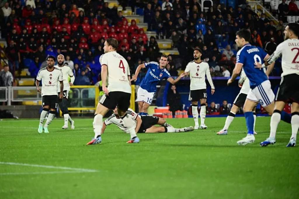 Como's Argentine midfielder #10 Nicolas Paz (C) scores his team's first goal during the UEFA Champions League, league phase matchday 3, football match between Como 1907 and Manchester United at the Stadio Giuseppe Sinigaglia in Como, northen Italy on October 21, 2026. PIERO CRUCIATTI / AFP
