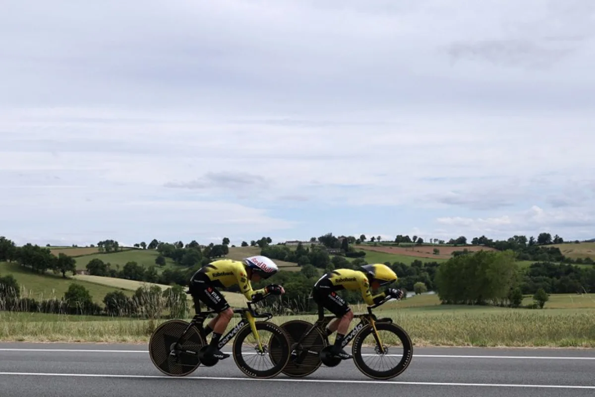 Team Visma | Lease a Bike's Belgian rider Wout Van Aert (L) cycles during the 3rd stage of the Tour Auvergne-Rhone-Alpes cycling race (formerly known as the Criterium du Dauphine), 28,4km team time trial departing and arriving in Perreux central France, on June 9, 2026.  Anne-Christine POUJOULAT / AFP