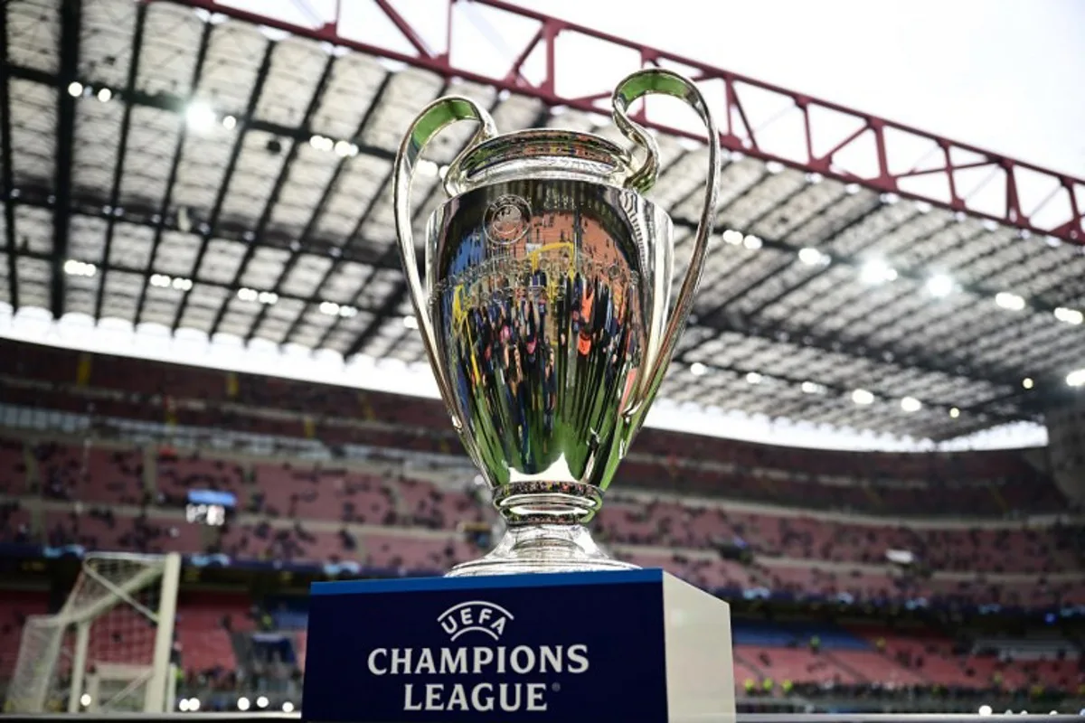 The UEFA Champions League trophy is displayed on the pitch prior to the UEFA Champions League semi-final second leg football match between Inter Milan and AC Milan on May 16, 2023 at tyhe Giuseppe-Meazza (San Siro) stadium in Milan.  Marco BERTORELLO / AFP