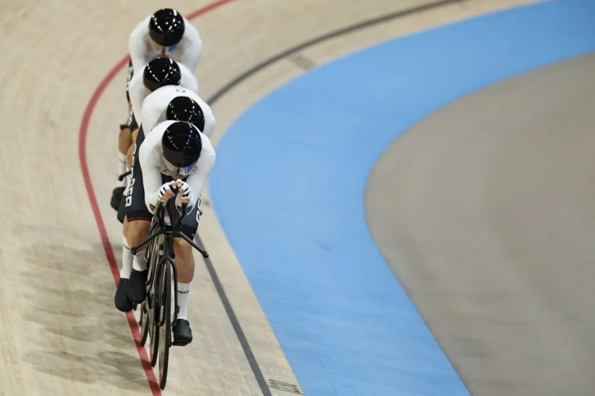 Germany's Roger Kluge, Germany's Tim Torn Teutenberg, Germany's Tobias Buck-Gramcko and Germany's Theo Reinhardt compete in the men's track cycling team pursuit qualifying round of the Paris 2024 Olympic Games at the Saint-Quentin-en-Yvelines National Velodrome in Montigny-le-Bretonneux, south-west of Paris, on August 5, 2024.  EMMANUEL DUNAND / AFP