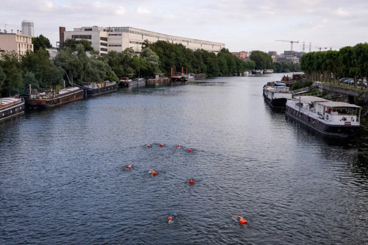 A group of swimmers enjoy the River Seine in Ile-Saint-Denis, north of Paris on July 2, 2023.   It is still prohibited to swim in the river Seine, but a year before the Olympic Games, which should inaugurate the reunion between this practice and the river, a group of pioneer swimmers fears neither the pollution, nor the Police. Geoffroy Van der Hasselt / AFP