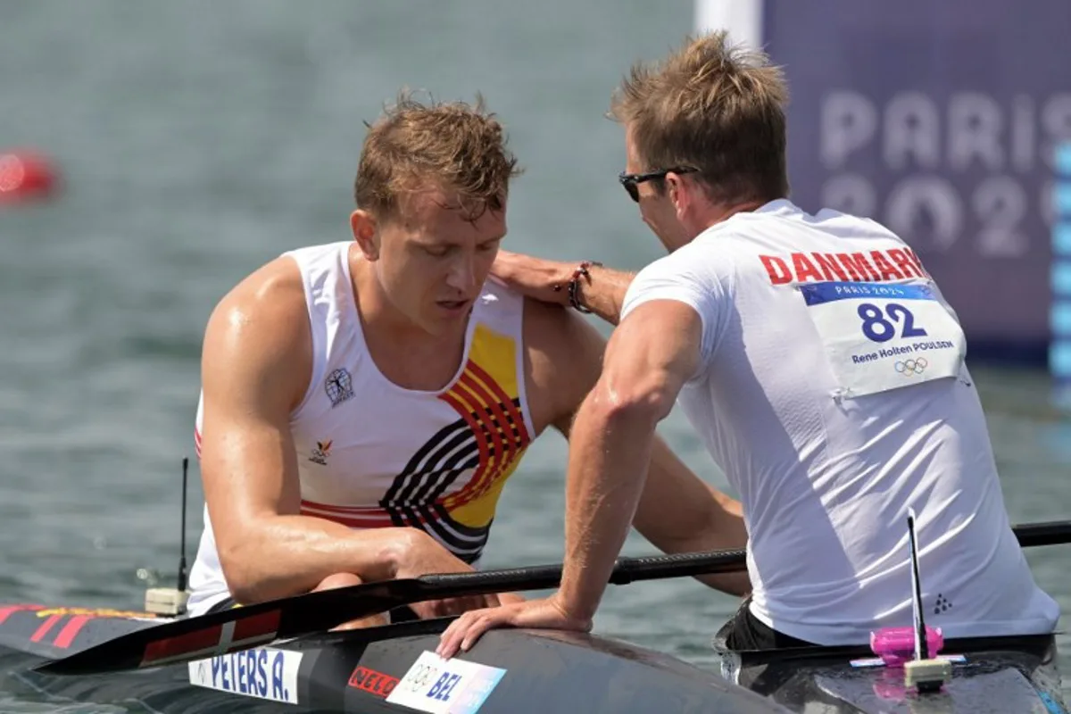 Denmark's Rene Holten Poulsen conforts Belgium's Artuur Peters (L) after the men's kayak single 1000m quarterfinals canoe sprint competition at Vaires-sur-Marne Nautical Stadium in Vaires-sur-Marne during the Paris 2024 Olympic Games on August 7, 2024. Bertrand GUAY / AFP