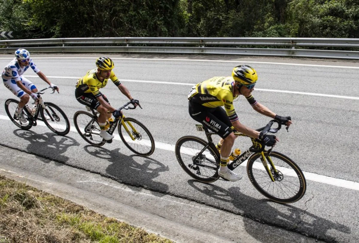 Team Visma-Lease a bike's Dutch rider Dylan van Baarle (R), Team Visma-Lease a bike's Belgian rider Victor Campenaerts (C) and Team UAE's Australian rider Jay Vine ride during the eleventh stage of the Vuelta a Espana cycling tour, a 167 km race from Bilbao to Bilbao, on September 3, 2025. ANDER GILLENEA / AFP