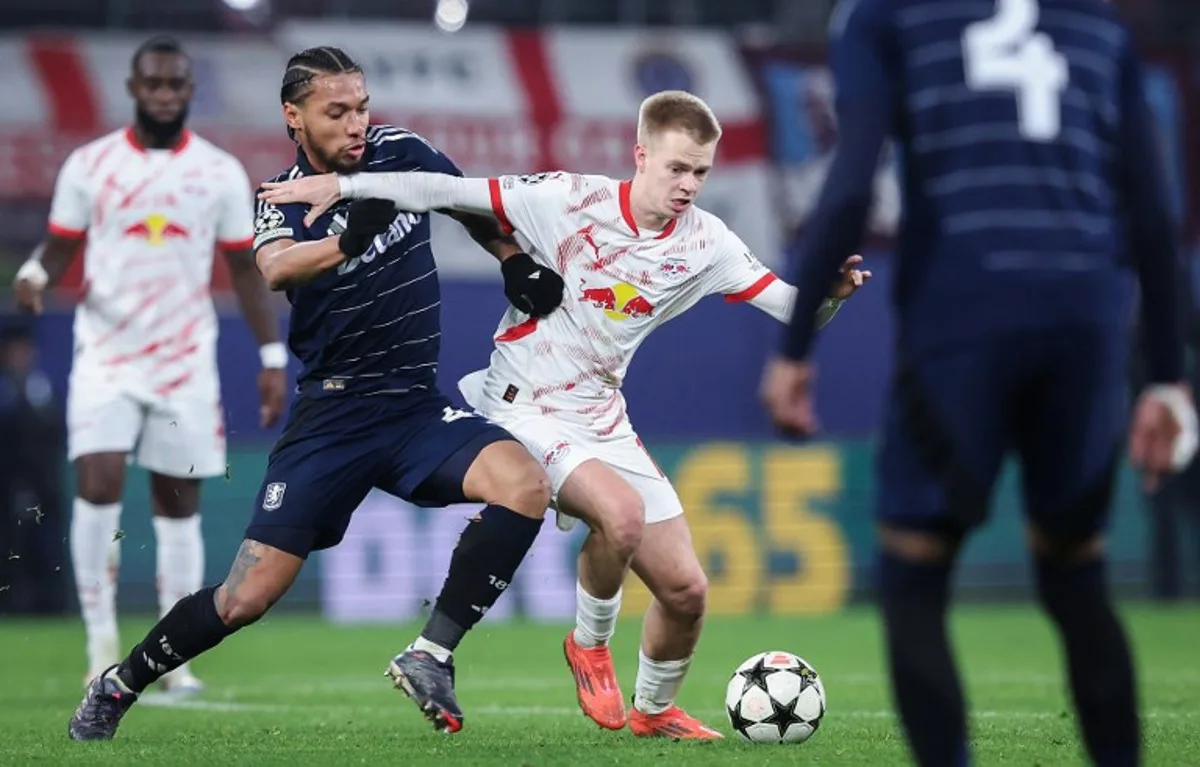 Aston Villa's French midfielder #44 Boubacar Kamara (L) and Leipzig's Belgian midfielder #18 Arthur Vermeeren vie for the ball during the UEFA Champions League football match between RB Leipzig and Aston Villa at the RB Arena in Leipzig, eastern Germany on December 10, 2024.  Ronny Hartmann / AFP