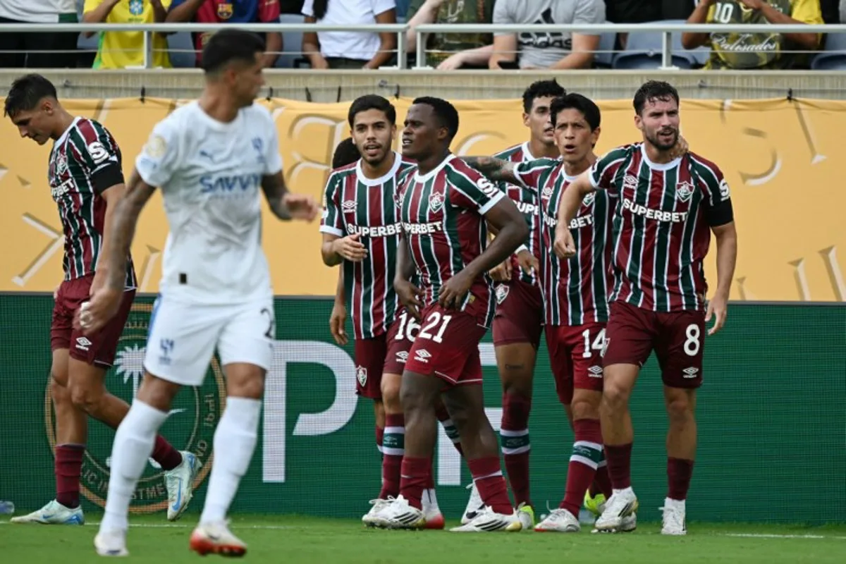 Fluminense's Brazilian midfielder #08 Martinelli celebrates with teammates after scoring his team's first goal during the FIFA Club World Cup 2025 quarterfinal football match between Brazil's Fluminense and Saudi Arabia's Al-Hilal at the Camping World Stadium in Orlando on July 4, 2025. CHANDAN KHANNA / AFP