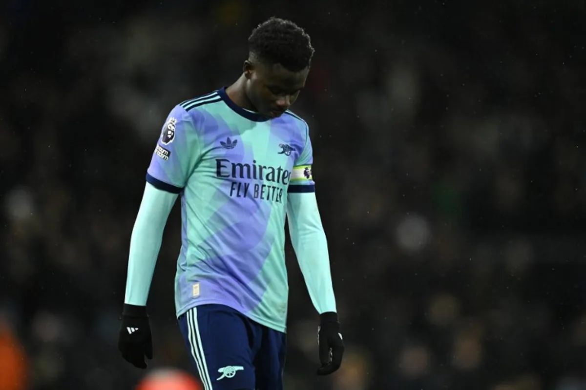 Arsenal's English midfielder #07 Bukayo Saka reacts on the pitch after the English Premier League football match between Fulham and Arsenal at Craven Cottage in London on December 8, 2024. The game finished 1-1. JUSTIN TALLIS / AFP