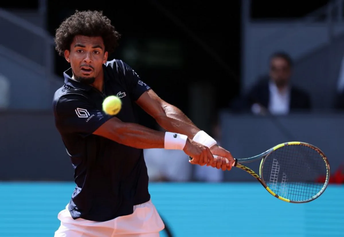 France's Arthur Fils returns the ball to Italy's Jannik Sinner during their 2026 ATP Tour Madrid Open tennis tournament semi-final singles match at the Caja Magica in Madrid, on May 1, 2026.  Thomas COEX / AFP