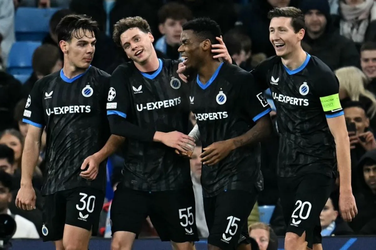 Club Brugge's Nigerian midfielder #15 Raphael Onyedika is mobbed by teammates after scoring the opening goal during the UEFA Champions League football match between Manchester City and Club Brugge at the Etihad Stadium in Manchester, north west England, on January 29, 2025.  Paul ELLIS / AFP