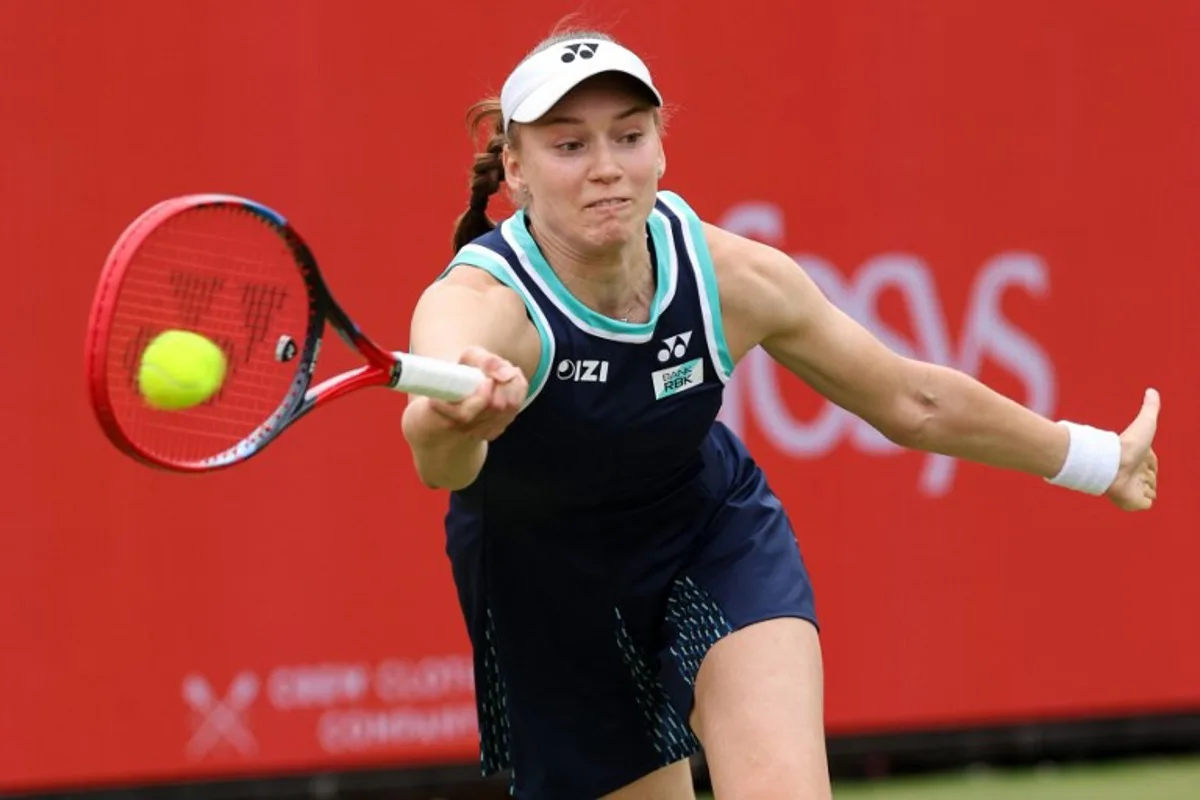 Kazakhstan's Elena Rybakina returns the ball during her round of 16 women's singles match against Germany's Tatjana Maria at the HSBC WTA tennis Championships at Queen's Club in west London on June 12, 2026.  Adrian Dennis / AFP