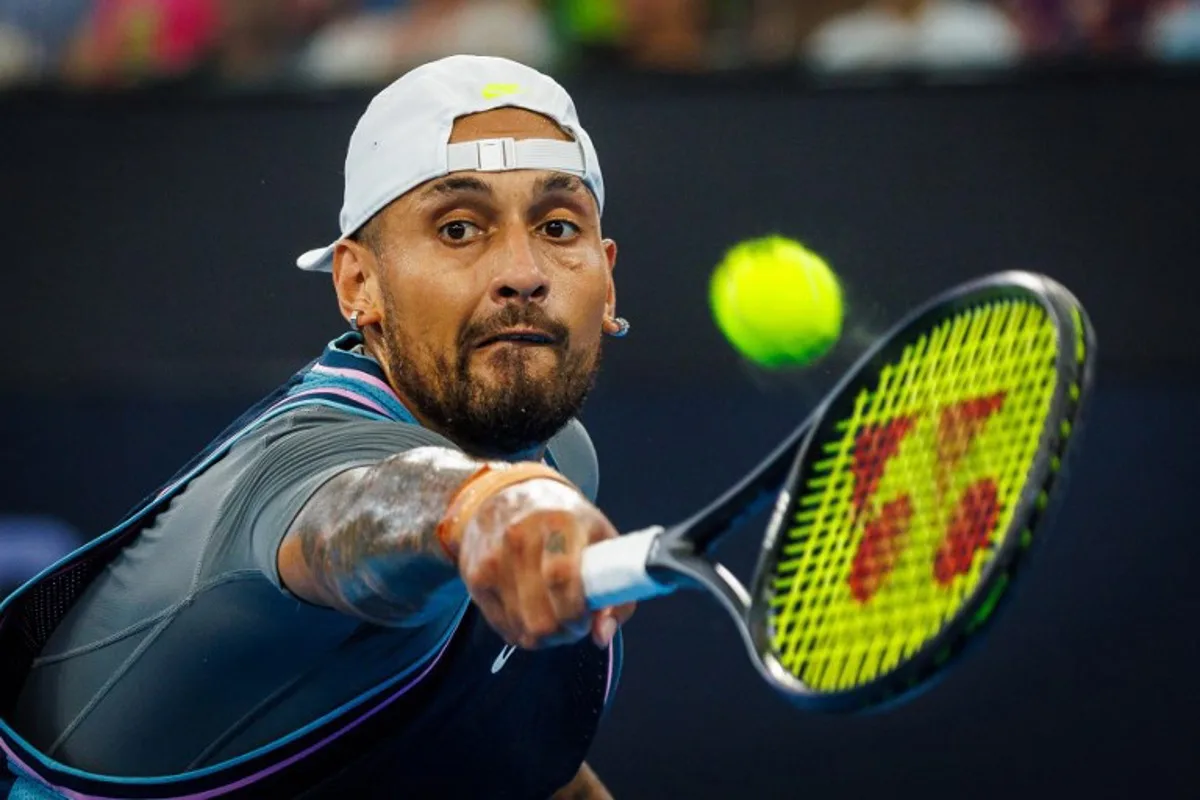 Australia's Nick Kyrgios hits a return against France's Giovanni Mpetshi Perricard during their men's singles match at the Brisbane International tennis tournament in Brisbane on December 31, 2024.  Patrick HAMILTON / AFP