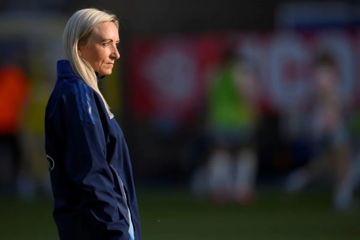Belgium's Icelandic coach Elisabet Gunnarsdottir stands on the pitch as her players warm up before the start of the UEFA Women's Nations League group A3 football match between Belgium and Spain at the King Power at Den Dreef Stadium, in Leuven on May 30, 2025. JOHN THYS / AFP