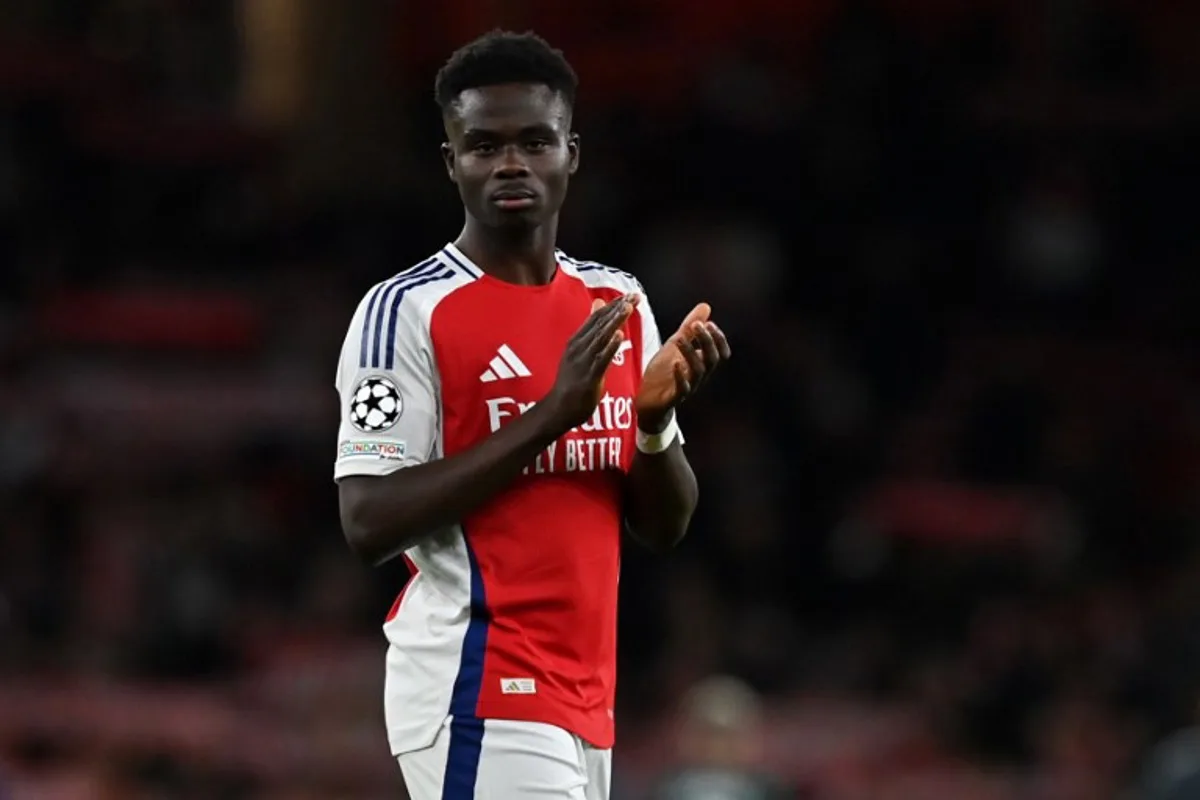 Arsenal's English midfielder #07 Bukayo Saka applauds the fans following the UEFA Champions League football match between Arsenal and Monaco at the Emirates Stadium in north London, on December 11, 2024. Arsenal won the match 3-0. Glyn KIRK / AFP