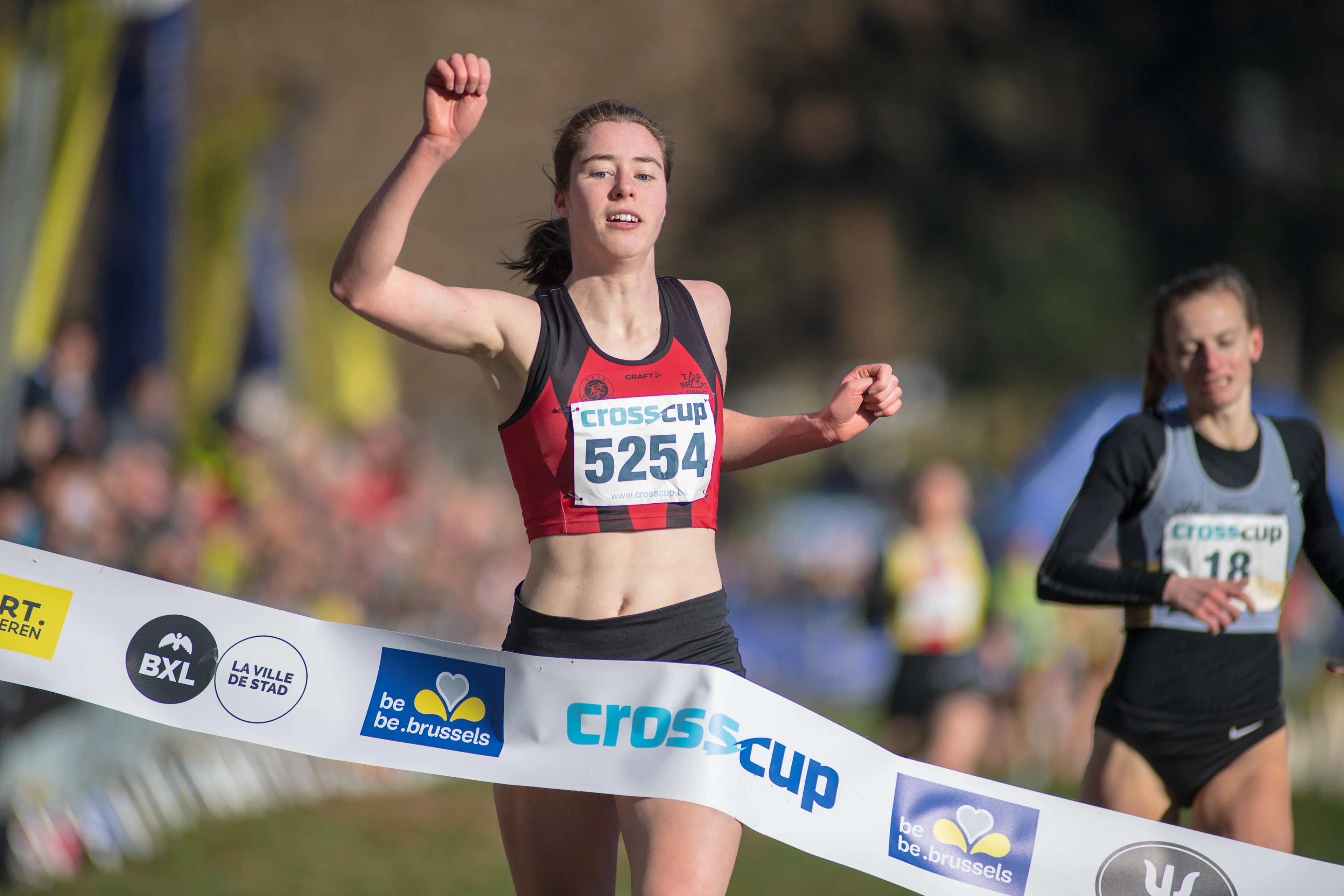 Belgian Marie Bilo celebrates as she crosses the finish line to win the short women's race at the CrossCup cross country running athletics event in Brussels, the sixth stage of the CrossCup competition and the Belgian Championships, Sunday 26 February 2023. BELGA PHOTO LUCIEN LAMBOTTE