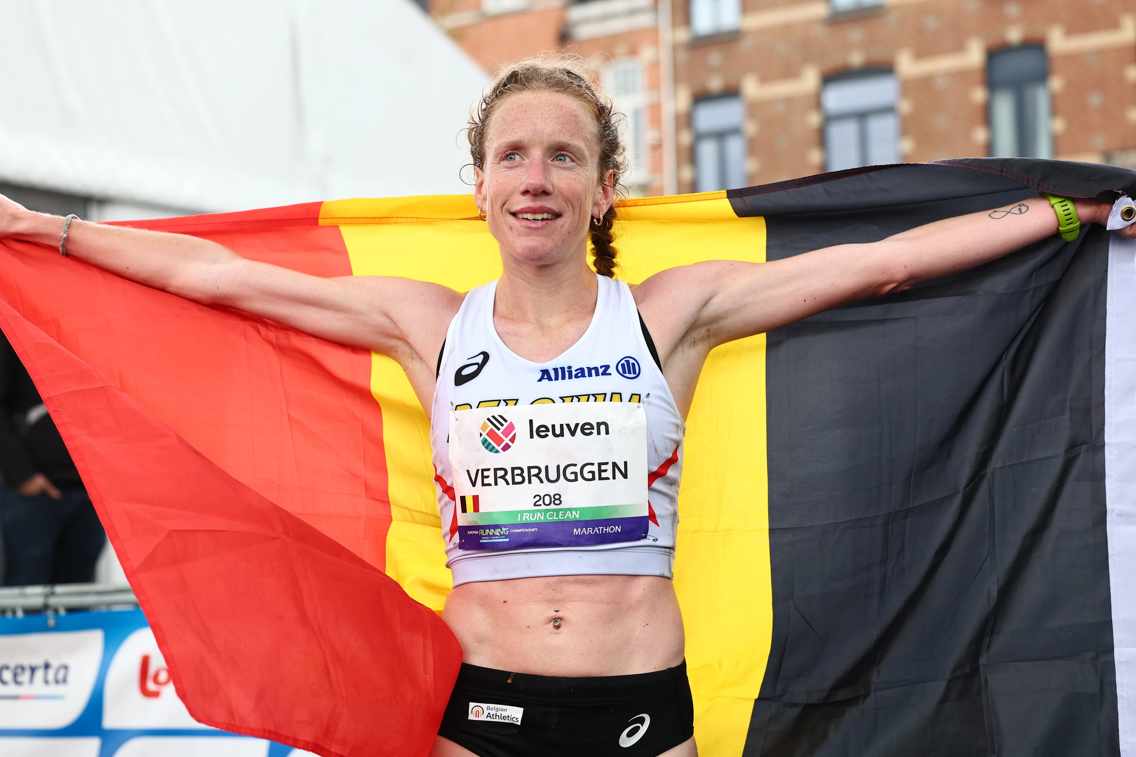Belgian Hanne Verbruggen poses with a Belgian flag at the women marathon race at European Running Championships, from Leuven to Brussels, Sunday 13 April 2025. BELGA PHOTO DAVID PINTENS