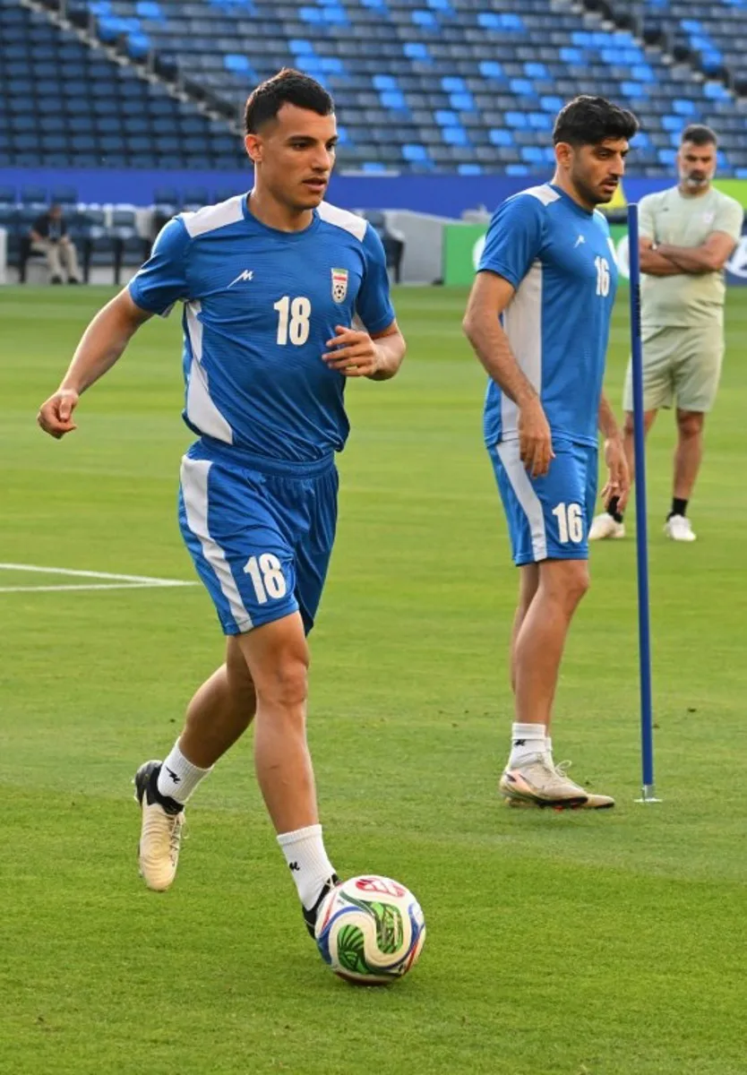 Iran's forward #18 Amirhossein Hosseinzadeh and Iran's midfielder #16 Mehdi Torabi take part in a training session at Carson Sports Park in Carson, California on June 14, 2026, on the eve of the 2026 World Cup football match between Iran and New Zealand.   Patrick T. Fallon / AFP