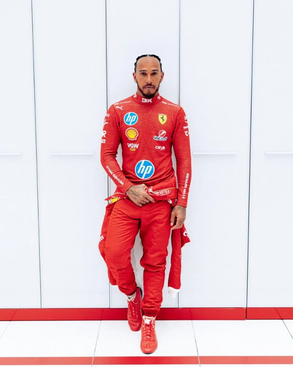 This handout picture released by Ferrari on January 22, 2024 shows F1 driver Lewis Hamilton wearing the Ferrari suit during a photo session. Lewis Hamilton drove a Ferrari Formula One car for the first time on January 22, 2024 after the seven-time world champion took to the track at the team's test circuit in front of delighted fans.  Handout / FERRARI / AFP