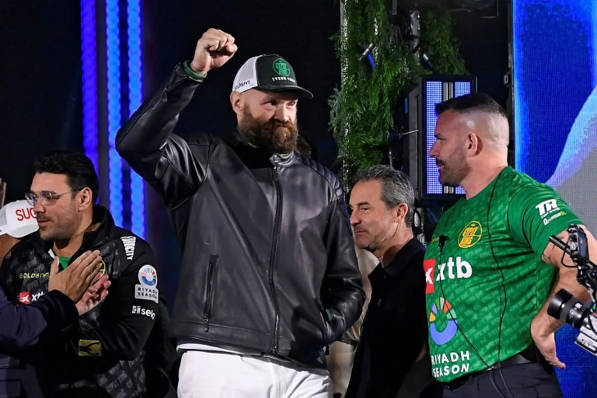 Britain's Tyson Fury (C) gestures on stage during the official weigh-in on the eve of his undisputed heavyweight world championship rematch against Ukraine's Oleksandr Usyk in Riyadh on December 20, 2024.  AFP