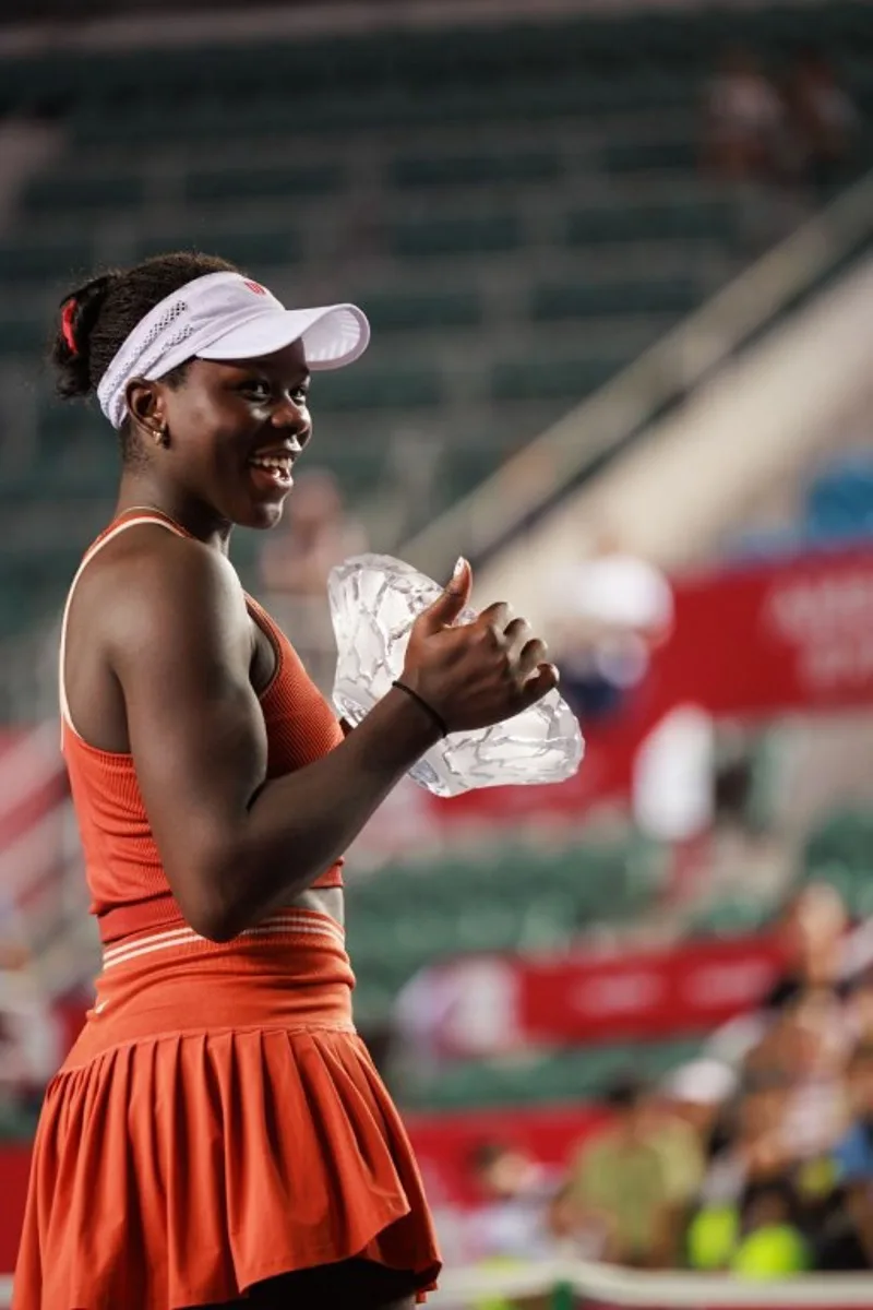 Victoria Mboko of Canada holds the trophy after winning against Cristina Bucsa of Spain in the women's singles final of the Hong Kong Tennis Open in Hong Kong on November 2, 2025. May JAMES / AFP