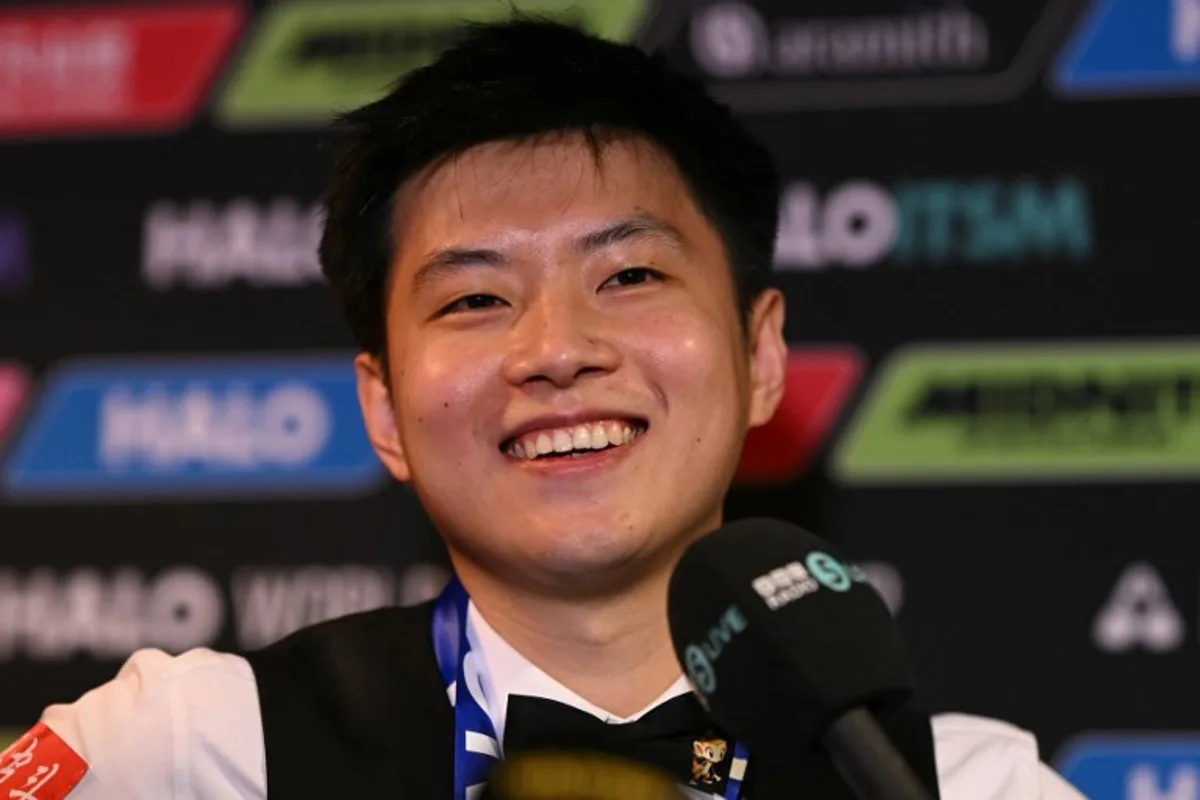 China's Zhao Xintong reacts at a press conference after victory over Wales' Mark Williams in the World Championship Snooker final at The Crucible in Sheffield, northern England on May 5, 2025. Zhao Xintong became the first Chinese player to win the World Snooker Championship as the qualifier completed his stunning march to the title with a 18-12 victory against Mark Williams in the final on Monday. Oli SCARFF / AFP