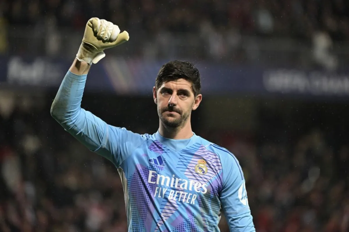 Real Madrid's Belgian goalkeeper #01 Thibaut Courtois gestures to supporters after Real Madrid won the UEFA Champions League, league phase - matchday 8 between Stade Brestois 29 (Brest) and Real Madrid CF at the Roudourou Stadium in Guingamp, north-western France, on January 29, 2025.   Damien MEYER / AFP