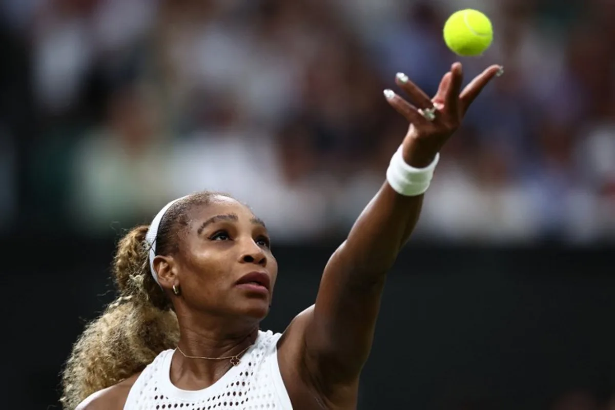 US player Serena Williams serves the ball to Australia's Maya Joint during their women's singles first round tennis match on the second day of the 2026 Wimbledon Championships at The All England Lawn Tennis and Croquet Club in Wimbledon, southwest London, on June 30, 2026. HENRY NICHOLLS / AFP