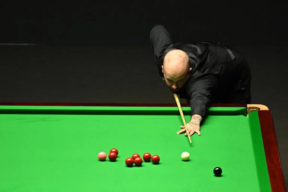 Belgium's Luca Brecel plays a shot against England's Mark Selby during the evening session on day two of their World Championship Snooker final match at The Crucible in Sheffield, northern England on May 1, 2023.   Oli SCARFF / AFP