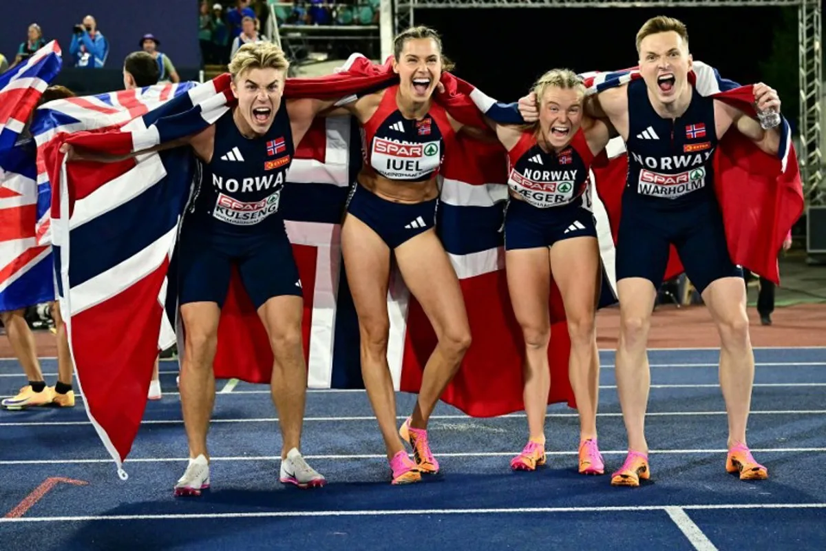 Gold medallists Norway's Andreas Ofstad Kulseng, Norway's Amalie Iuel Norway's Henriette Jaeger and Norway's Karsten Warholm celebrate after competing in the mixed 4x400m relay final during the European Athletics Championships at Alexander Stadium in Birmingham on August 10, 2026.  Ben STANSALL / AFP