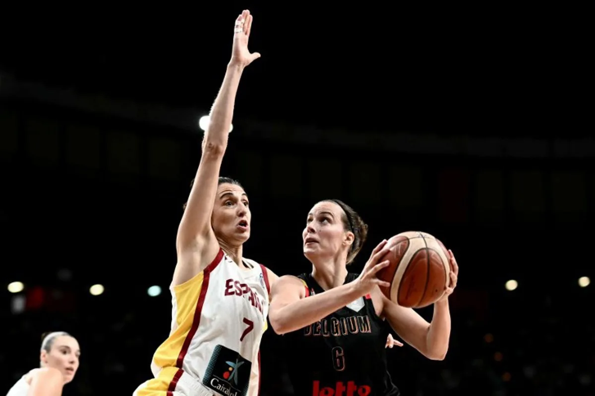 Belgium's small forward Antonia Delaere (R) attacks the rim as she is defended by Spain's small forward Alba Torrens during the FIBA Women's EuroBasket 2025 final match between Spain and Belgium at the Peace and Friendship Stadium in Athens on June 29, 2025. Angelos Tzortzinis / AFP