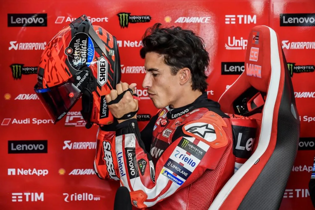 Ducati Lenovo Team's Marc Marquez puts on his helmet prior to the Practice session at the Balaton Park Circuit in Balatonfokajar, Hungary, on June 5, 2026, ahead of the Hungarian Motorcycle MotoGP Grand Prix. FERENC ISZA / AFP