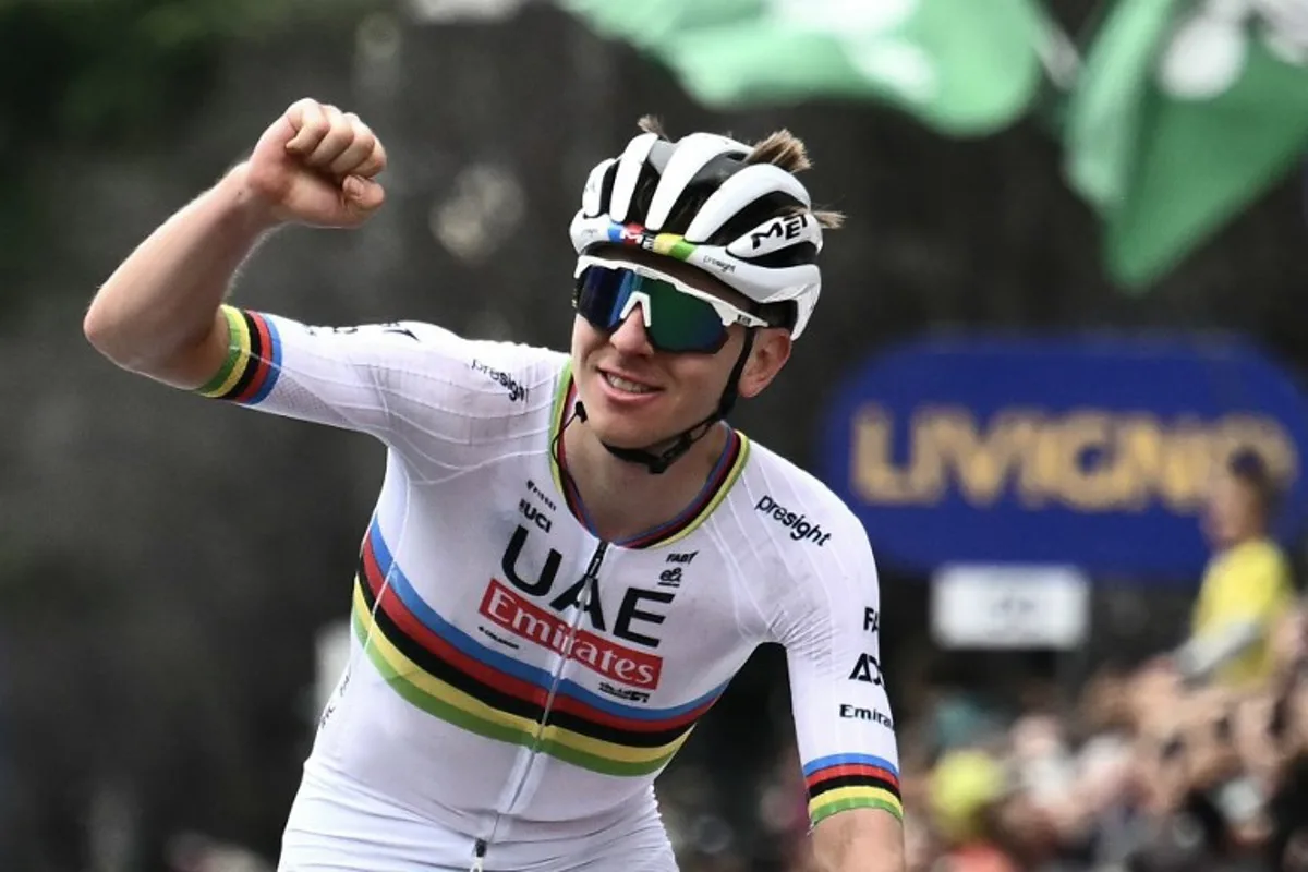 UAE Team Emirates team's Slovenian rider Tadej Pogacar celebrates his victory as he cycles to win the 118th edition of the Giro di Lombardia (Tour of Lombardy), a 252km cycling race from Bergamo to Como on October 12, 2024.  Marco BERTORELLO / AFP