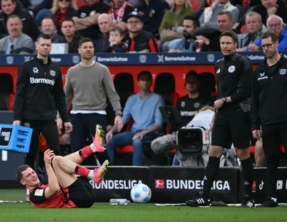 Bayer Leverkusen's German midfielder #10 Florian Wirtz reacts injured on the pitch during the German first division Bundesliga football match between Bayer Leverkusen and Werder Bremen in Leverkusen, western Germany, on March 8, 2025.  INA FASSBENDER / AFP