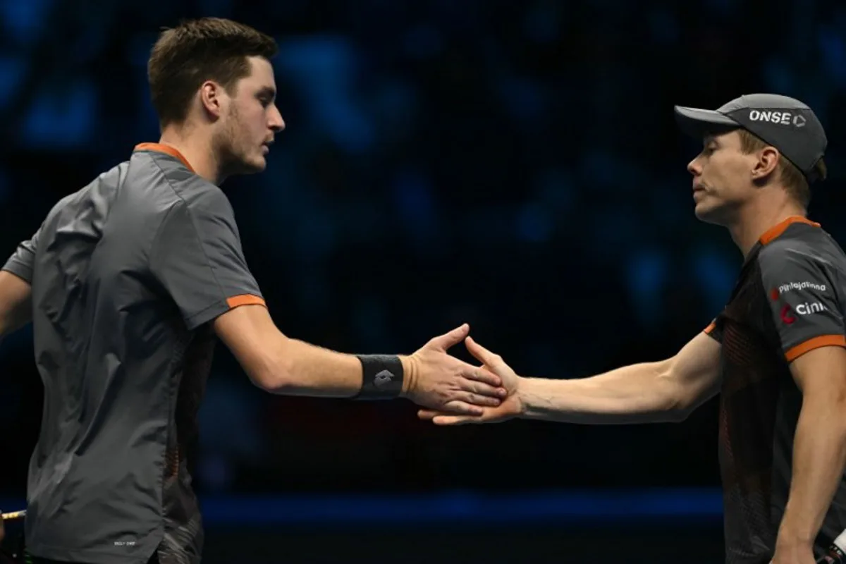 British Henry Patten and Finnish Harri Heliovaara celebrate celebrate a point against British Joe Salisbury and British Neal Skupski during the final of the double at the ATP Finals tennis tournament in Turin on November 16, 2025. Marco BERTORELLO / AFP