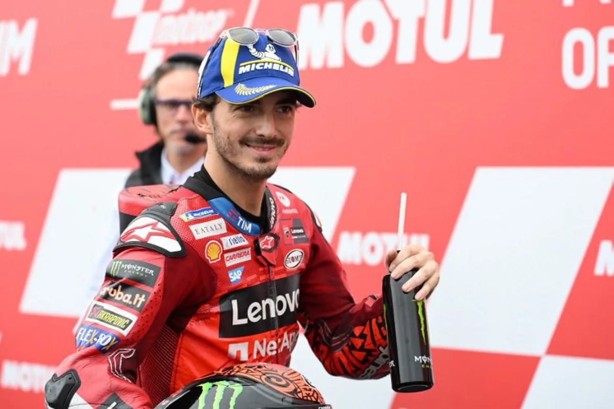 Ducati Lenovo Team rider Francesco Bagnaia of Italy smiles after getting the second starting position at the parc ferme of the MotoGP class qualifying session of MotoGP Japanese Grand Prix at the Mobility Resort Motegi in Motegi, Tochigi prefecture on October 5, 2024.  Toshifumi KITAMURA / AFP