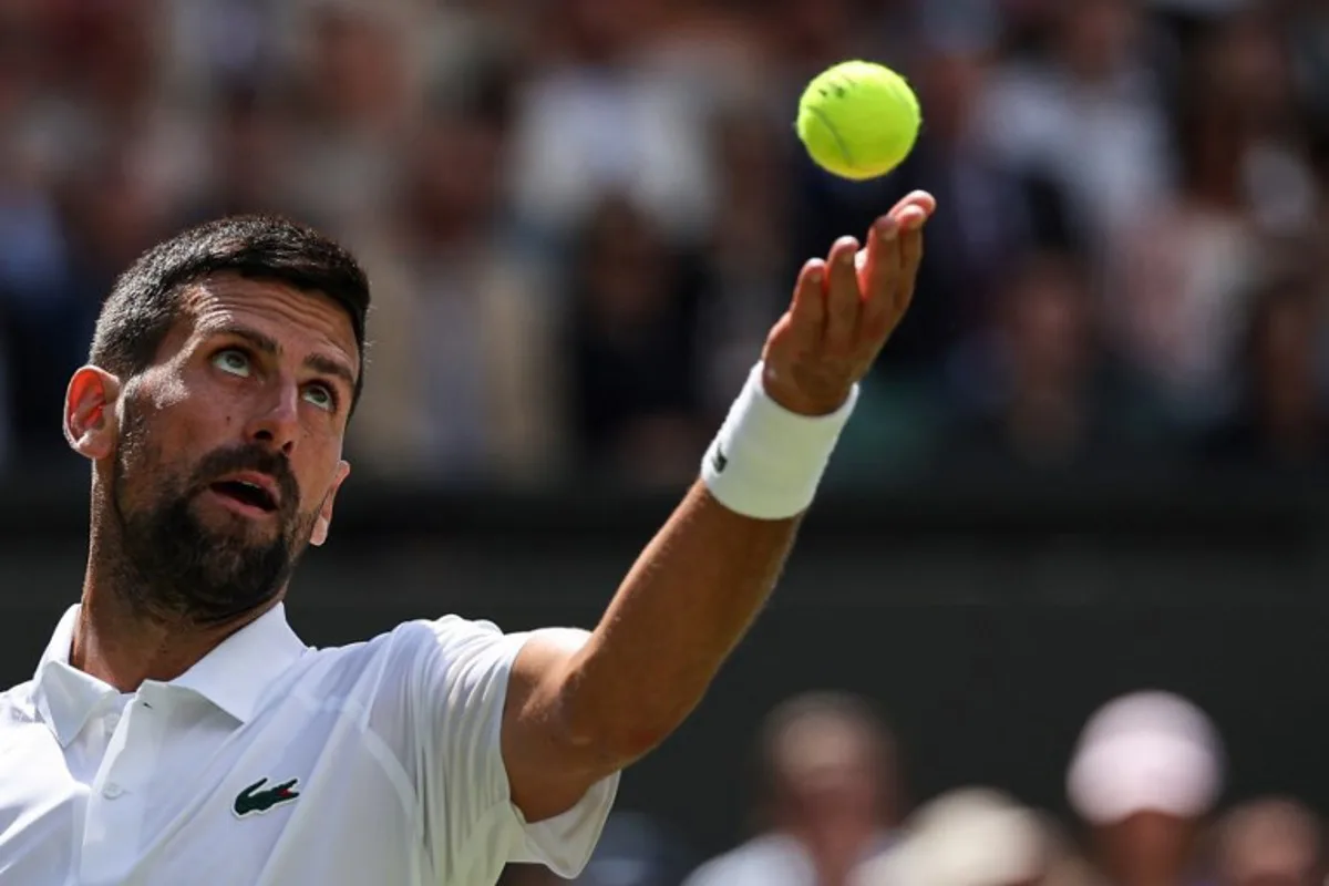Serbia's Novak Djokovic serves to Britain's Daniel Evans during their men's singles second round tennis match on the fourth day of the 2025 Wimbledon Championships at The All England Lawn Tennis and Croquet Club in Wimbledon, southwest London, on July 3, 2025.  Adrian Dennis / AFP