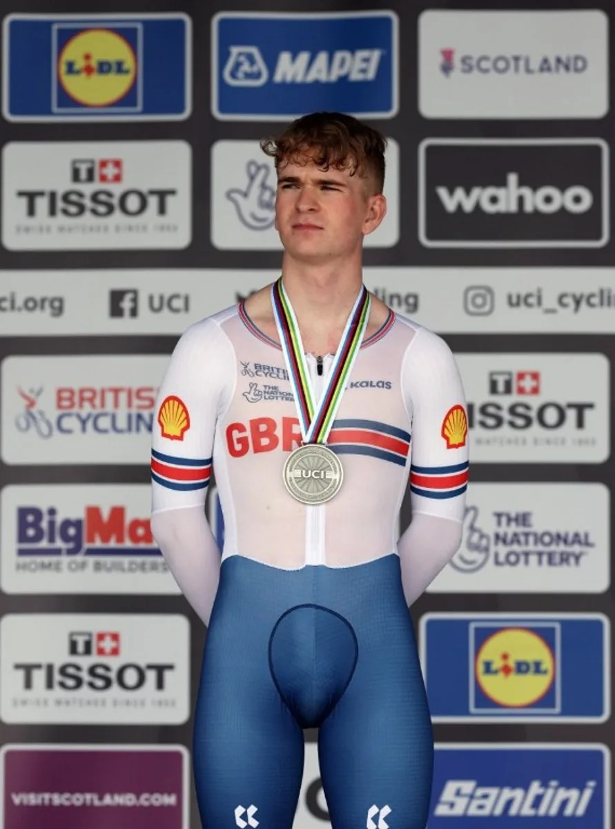 Great Britain's Ben Wiggins celebrates with his silver medal after winning the men's Junior Individual Time Trial in Stirling during the UCI Cycling World Championships in Scotland on August 11, 2023. Great Britain's Ben Wiggins won silver and Germany's Louis Leidert won bronze. Adrian DENNIS / AFP