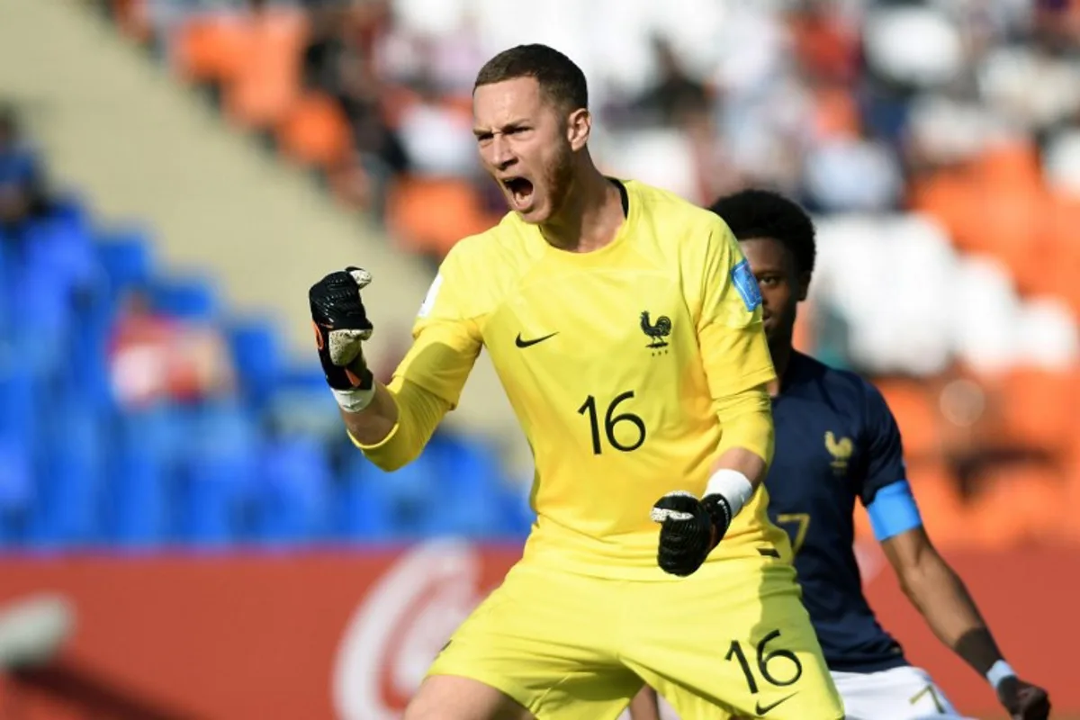 France's goalkeeper Yann François Lienard celebrates after saving a penalty during the Argentina 2023 U-20 World Cup Group F football match between France and Gambia at the Malvinas Argentinas stadium in Mendoza, Argentina, on May 25, 2023.  Andres Larrovere / AFP
