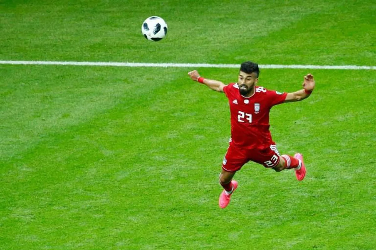 Iran's defender Ramin Rezaian heads the ball during the Russia 2018 World Cup Group B football match between Iran and Spain at the Kazan Arena in Kazan on June 20, 2018.  BENJAMIN CREMEL / AFP RESTRICTED TO EDITORIAL USE - NO MOBILE PUSH ALERTS/DOWNLOADS

