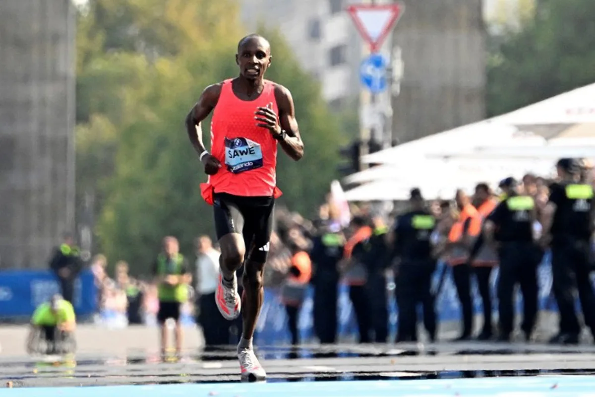 Kenya's Sabastian Sawe arrives in the finish area before  winning the 51st edition of the Berlin Marathon in Berlin, Germany on September 21, 2025.  Tobias SCHWARZ / AFP