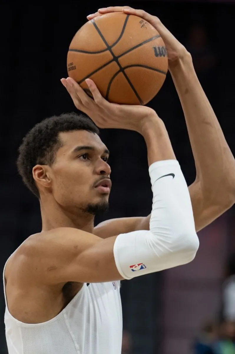 San Antonio Spurs' French forward #01 Victor Wembanyama warms up ahead of the NBA game between the San Antonio Spurs and the Minnesota Timberwolves at the Frost Bank Center in San Antonio, Texas, on January 27, 2024.  SUZANNE CORDEIRO / AFP