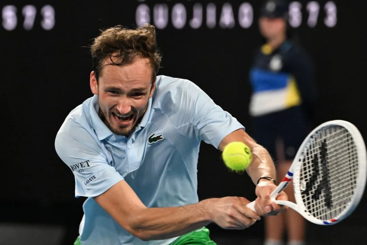 Russia's Daniil Medvedev hits a return against USA's Learner Tien during their men's singles match on day five of the Australian Open tennis tournament in Melbourne on January 17, 2025.  Paul Crock / AFP