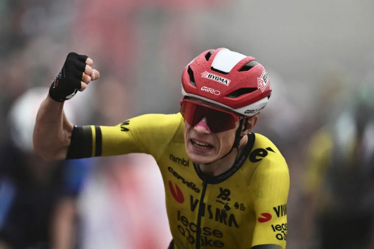 Team Visma-Lease a bike's Danish rider Jonas Vingegaard celebrates as he crosses the finish line to win the second stage of the Vuelta a Espana, a 159,6 km race between Alba and Limone Piemonte, in Italy's Piemonte region, on August 24, 2025. Marco BERTORELLO / AFP