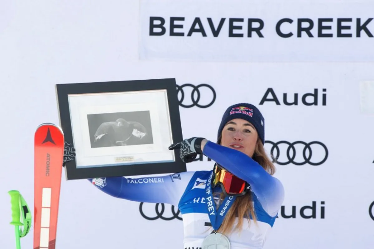 Sofia Goggia of Italy  celebrates on the podium after her second place finish in the Audi FIS Alpine Ski World Cup Women's Downhill race in Beaver Creek, Colorado, on December 14, 2024.   Jason Connolly / AFP