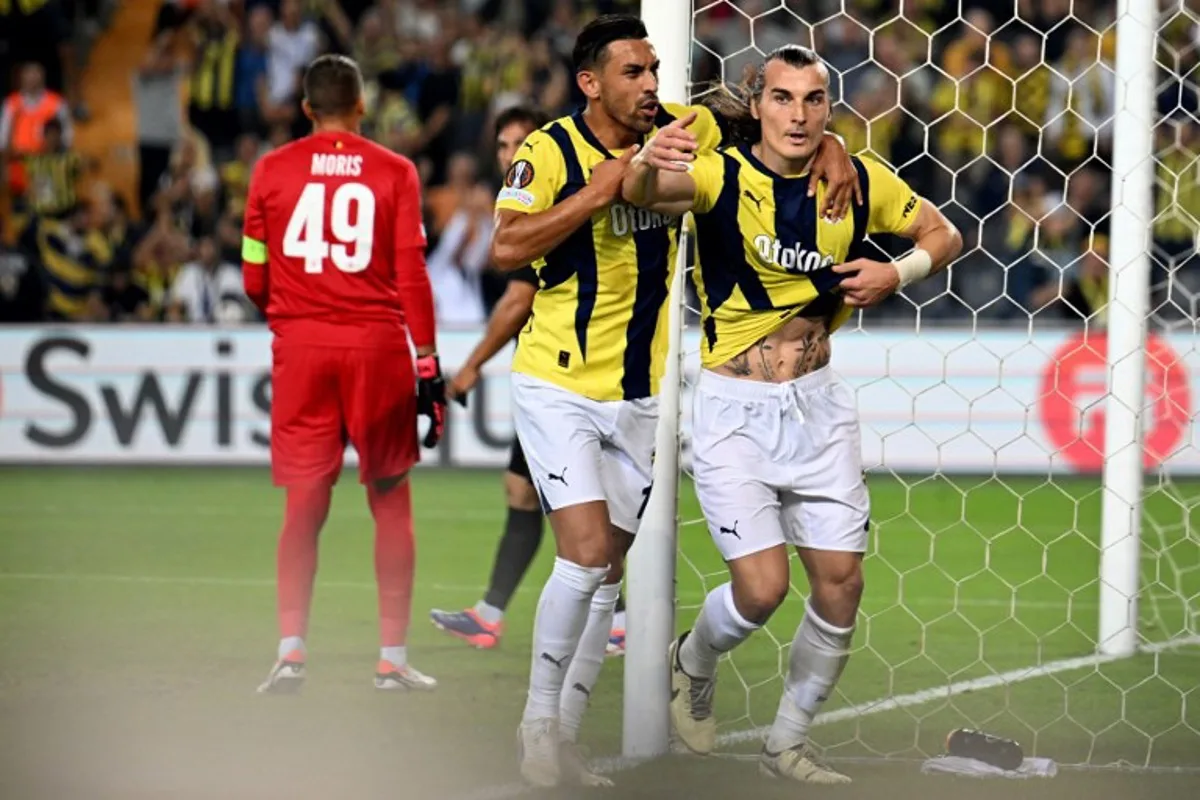 Fenerbahce's Turkish defender #04 Caglar Soyuncu (R) celebrates after scoring Fenerbahce's first goal during the UEFA Europa League 1st round day 1 football match between Fenerbahce SK and Union Saint-Gilloise at the Fenerbahce Sukru Saracoglu stadium in Istanbul, on September 26, 2024.  Ozan KOSE / AFP