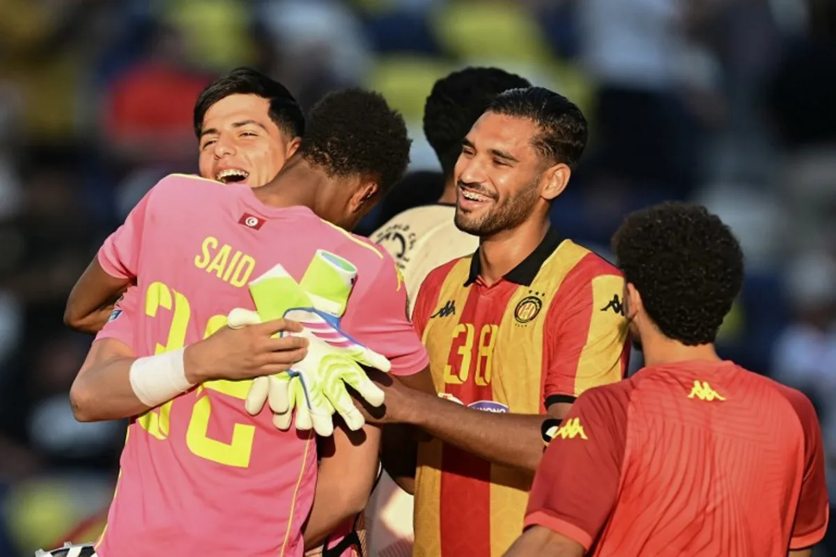 Esperance's Tunisian goalkeeper #32 Bechir Ben Said (C) celebrates with teammates Tunisian goalkeeper #01 Amenallah Memmiche and Tunisian midfielder #38 Khalil Guenichi after winning the FIFA Club World Cup 2025 Group D football match between US Los Angeles FC and Tunis' Esperance Sportive de Tunis at the Geodis Park stadium in Nashville on June 20, 2025. Paul ELLIS / AFP
