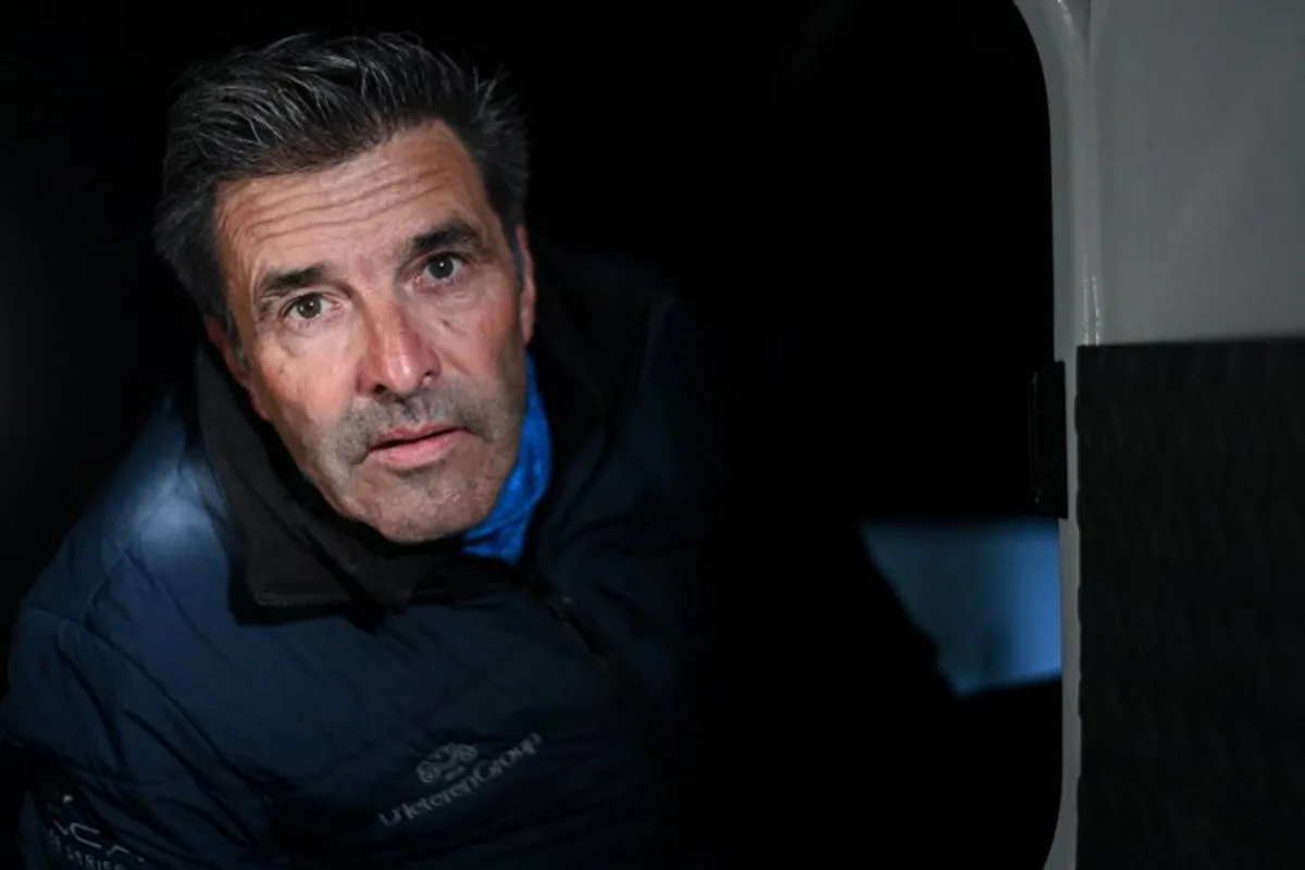 Belgian skipper Denis Van Weynbergh poses aboard his Imoca monohull "D'ieteren Group" ahead of the 10th edition of the Vendee Globe around the world monohull solo sailing race, at the Vendee Globe village in Les Sables-d'Olonne, western France on November 5, 2024.   Sebastien Salom-Gomis / AFP